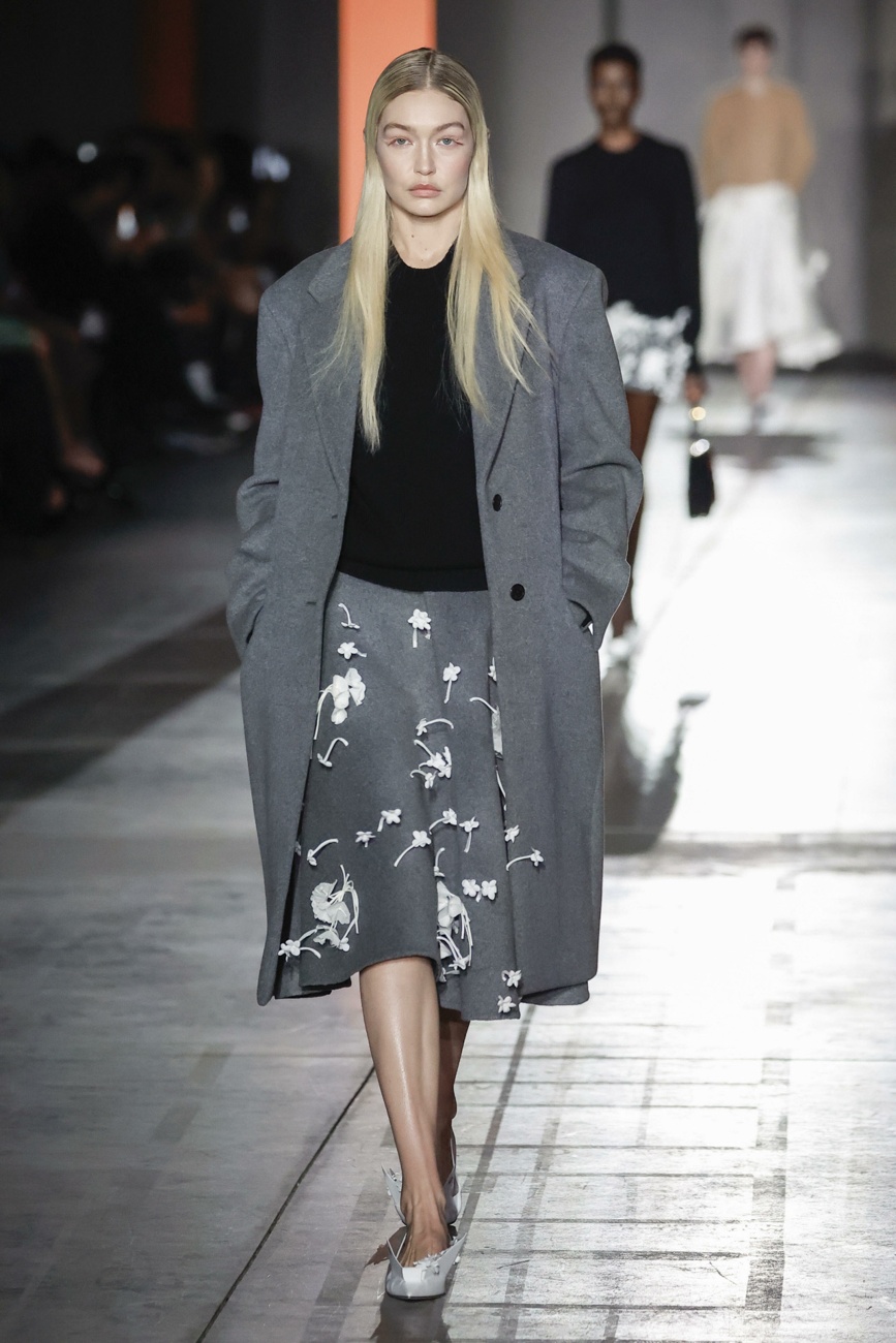 Gigi in a gray and black look with three-dimensional details